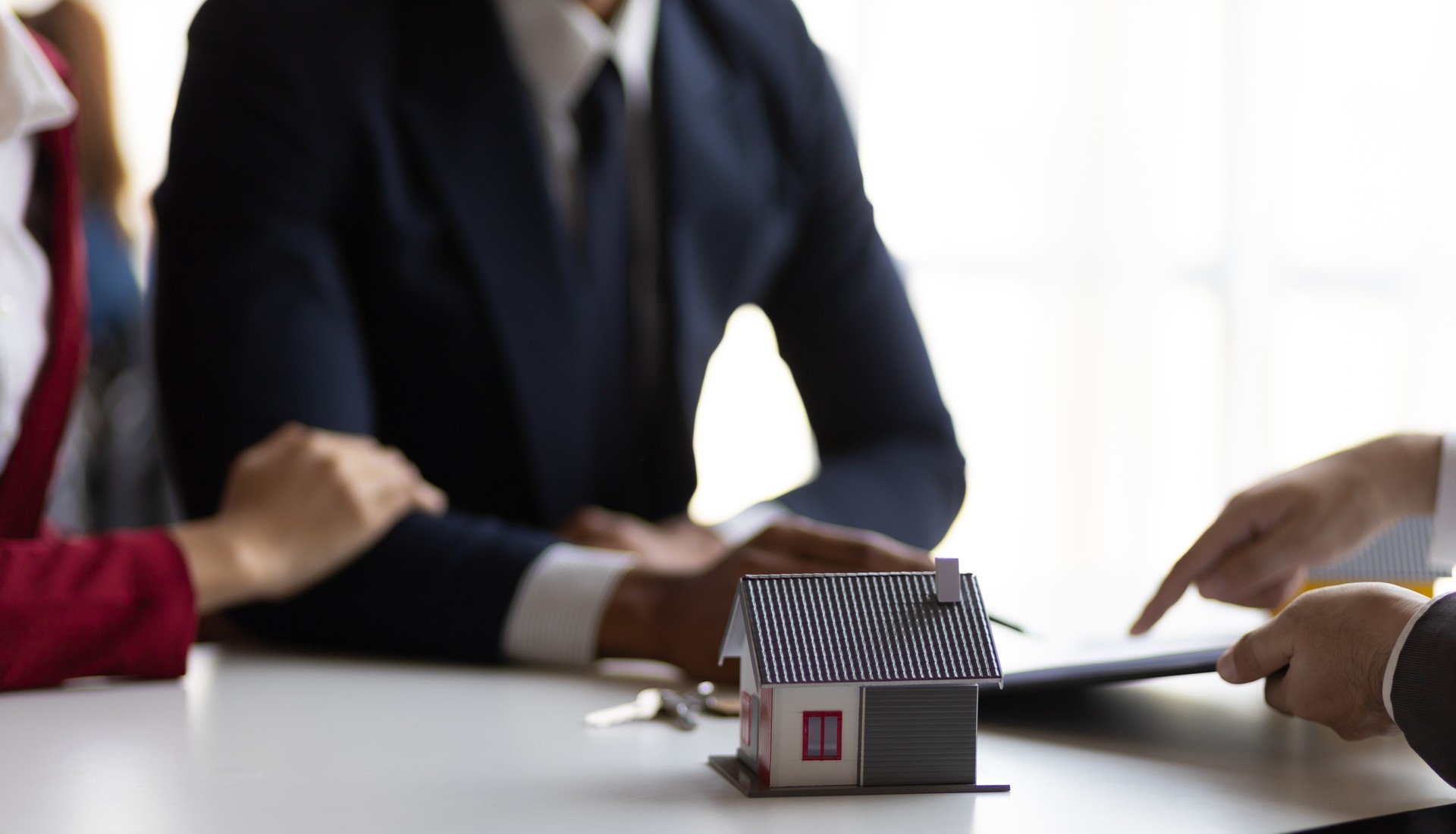 Businessman, real estate agent negotiating the signing of a home purchase agreement.